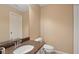 Neutral powder room boasts granite counters, designer fixtures, and a well-lit vanity at 1029 Ector Nw Dr, Kennesaw, GA 30152