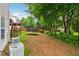 Backyard with green lawn and a glimpse of a wooden deck and play equipment at 2372 Wilshire Way, Douglasville, GA 30135