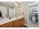 Bathroom featuring wood vanity, large mirror, and attached water closet at 2372 Wilshire Way, Douglasville, GA 30135