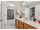 Bathroom featuring wood vanity, light-toned tiling, and glass-enclosed shower at 2372 Wilshire Way, Douglasville, GA 30135