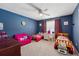 Blue bedroom featuring two twin beds, a pink sofa, and an array of furniture at 2372 Wilshire Way, Douglasville, GA 30135