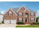 Charming two-story brick home with a well-manicured lawn, a two car garage and inviting front entrance at 2372 Wilshire Way, Douglasville, GA 30135