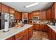 Spacious kitchen featuring cherry cabinets, granite counters, stainless steel appliances, and ample counter space at 2372 Wilshire Way, Douglasville, GA 30135