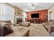 Inviting living room with a stone fireplace, stylish furniture, warm wall color and decorative accents at 2372 Wilshire Way, Douglasville, GA 30135