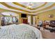 Spacious primary bedroom with tray ceilings, sitting area, and abundant natural light at 2372 Wilshire Way, Douglasville, GA 30135