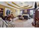 Expansive primary bedroom with tray ceilings, sitting area, and neutral carpeting at 2372 Wilshire Way, Douglasville, GA 30135