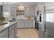 Updated kitchen featuring gray cabinets, granite countertops, and stainless steel appliances at 247 Ivey Ter, Temple, GA 30179