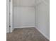 Spacious walk-in closet with white metal shelving and carpeted floors at 247 Ivey Ter, Temple, GA 30179