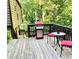 Inviting back deck with outdoor seating and a modern grill, perfect for entertaining and relaxation amongst lush greenery at 2694 Tritt Springs Ne Dr, Marietta, GA 30062