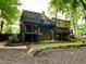 View of a multi-level backyard deck with mature landscaping and wooded surround at 2694 Tritt Springs Ne Dr, Marietta, GA 30062