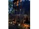 View of a backyard deck with a covered area, surrounded by landscape lighting and mature trees at 2694 Tritt Springs Ne Dr, Marietta, GA 30062