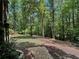 Serene backyard with manicured landscaping, stone pathways, a fire pit, offering a peaceful retreat in a lush setting at 2694 Tritt Springs Ne Dr, Marietta, GA 30062
