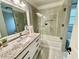 Modern bathroom with granite countertop vanity and a sleek glass-enclosed shower-tub at 2694 Tritt Springs Ne Dr, Marietta, GA 30062