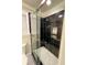 Modern bathroom with a black tiled shower, a glass door, and stainless steel shower fixtures at 2694 Tritt Springs Ne Dr, Marietta, GA 30062