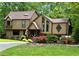 Inviting two-story home featuring a unique design, colorful landscaping, and charming front entrance at 2694 Tritt Springs Ne Dr, Marietta, GA 30062