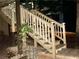 An outdoor staircase with a wooden handrail and built-in lights leads upwards in this nighttime shot at 2694 Tritt Springs Ne Dr, Marietta, GA 30062
