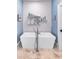 Contemporary bathroom featuring a freestanding tub, marble floors, and minimalist decor at 312 Stonemont Dr, Atlanta, GA 30305