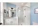 An updated bathroom with blue accent walls includes a glass enclosed shower and white vanity at 312 Stonemont Dr, Atlanta, GA 30305
