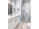 Elegant bathroom featuring a glass-enclosed shower, white vanity, and stylish light fixtures at 312 Stonemont Dr, Atlanta, GA 30305