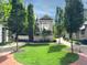 A courtyard framed by brick walkways features manicured landscaping, mature trees, and an outdoor pergola at 312 Stonemont Dr, Atlanta, GA 30305