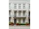 Charming three-story townhouse with a balcony, awnings, and beautiful landscaping at 312 Stonemont Dr, Atlanta, GA 30305