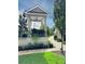 A verdant lawn is decorated with a white pergola with Corinthian columns and a wrought iron fence at 312 Stonemont Dr, Atlanta, GA 30305