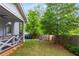 Large backyard featuring a covered porch, fire pit, fence, and plenty of space for outdoor activities at 3123 Cedar St, Scottdale, GA 30079
