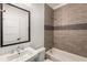 Bathroom showcasing tiled shower and tub with a decorative accent row at 3123 Cedar St, Scottdale, GA 30079