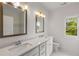 Elegant bathroom with double sinks, quartz countertop, and stylish fixtures at 3123 Cedar St, Scottdale, GA 30079