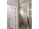 This bathroom features a tiled walk-in shower with a glass enclosure and a door to the water closet at 3123 Cedar St, Scottdale, GA 30079