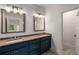 Bathroom features double sinks with modern fixtures, gray countertops and blue cabinets at 3123 Cedar St, Scottdale, GA 30079
