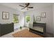 Cozy Bedroom with grey furniture, a decorative star rug, and ample natural light at 3123 Cedar St, Scottdale, GA 30079