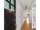 Bright hallway with hardwood floors and view into open living area at 3123 Cedar St, Scottdale, GA 30079