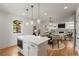 Modern kitchen island overlooking a dining area and a cozy living room at 3123 Cedar St, Scottdale, GA 30079
