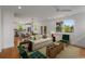Open-concept living room and dining area with hardwood floors and plenty of natural light at 3123 Cedar St, Scottdale, GA 30079