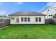 Exterior view of home featuring a well-maintained lawn, covered patio, and privacy fence at 423 Murphy Ave, Canton, GA 30114