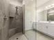 Modern bathroom featuring a walk-in shower with gray tiling and double sink vanity with white cabinets at 423 Murphy Ave, Canton, GA 30114