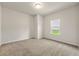 A bedroom featuring carpet flooring, a window with outside views, and neutral walls at 423 Murphy Ave, Canton, GA 30114