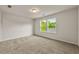Bright bedroom featuring plush carpeting and double windows with views of lush greenery at 423 Murphy Ave, Canton, GA 30114
