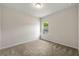 A cozy bedroom featuring neutral carpet, ample natural light, and simple finishes at 423 Murphy Ave, Canton, GA 30114