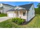Charming home with a brick and siding exterior, attached garage, and manicured front lawn at 423 Murphy Ave, Canton, GA 30114