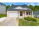 Charming single-Gathering home featuring a well-manicured lawn, attached garage, and inviting entryway at 423 Murphy Ave, Canton, GA 30114