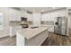 Kitchen features white cabinets, stainless appliances, granite counters and a kitchen island at 423 Murphy Ave, Canton, GA 30114