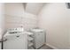 Laundry room featuring modern washer and dryer appliances and wire shelving for storage at 423 Murphy Ave, Canton, GA 30114