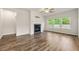 Living room with a fireplace, wood floors, and plenty of natural light from the windows at 423 Murphy Ave, Canton, GA 30114