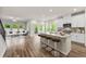 Bright, open-concept living room and kitchen area with hardwood floors and stainless steel appliances at 423 Murphy Ave, Canton, GA 30114