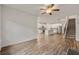 Open concept living space showcasing a kitchen, living room, and open staircase with hardwood floors at 423 Murphy Ave, Canton, GA 30114