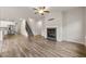 Spacious living room featuring a fireplace, staircase, and adjacent kitchen with stainless steel appliances at 423 Murphy Ave, Canton, GA 30114