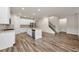 Open floor plan with kitchen island, stainless steel dishwasher, and open staircase at 423 Murphy Ave, Canton, GA 30114