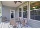 Covered back porch with outdoor seating, a ceiling fan, and serene backyard views at 514 Creekshire Cir, Canton, GA 30115